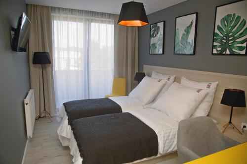 a bedroom with a large bed and a couch at B&B ALIBI in Bardejov