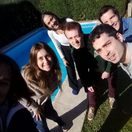 a group of people standing next to a swimming pool at La Providencia in Yerba Buena