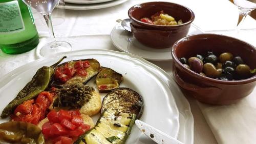 a plate of food with vegetables on a table at Agriturismo Masseria Cannella in Lesina