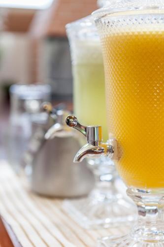 a glass of orange juice sitting on top of a counter at Pousada Cajueiro Trancoso in Trancoso