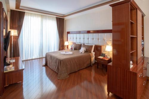 a hotel room with a bed and a window at Khazri in Baku