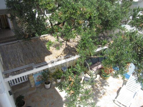 an overhead view of a garden with a bench and trees at Apartments Villa Bella Vista Hvar in Hvar