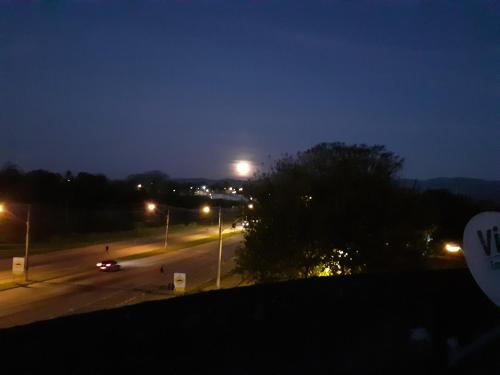 a view of a street at night with street lights at POUSADA PERLLA's Pindamonhangaba in Pindamonhangaba