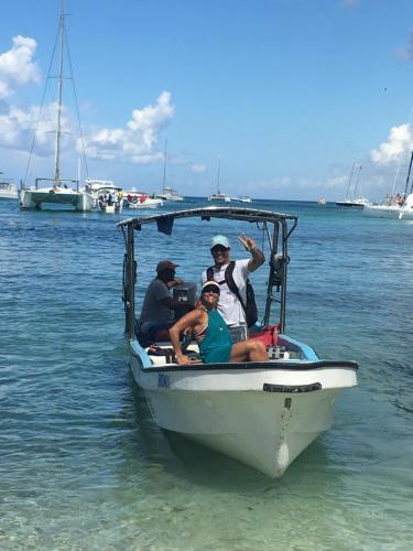 a group of people sitting in a boat in the water at Albergo El Pulpo, Bayahíbe in Bayahibe