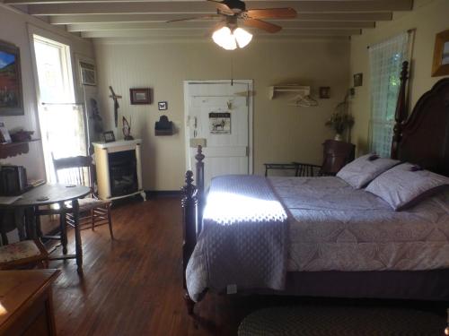 a bedroom with a bed and a ceiling fan at Mulberry Lavender Farm and B&B in Mulberry