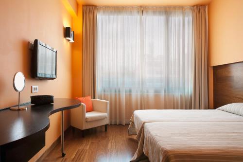 a hotel room with two beds and a television at Athens Center Square Hotel in Athens