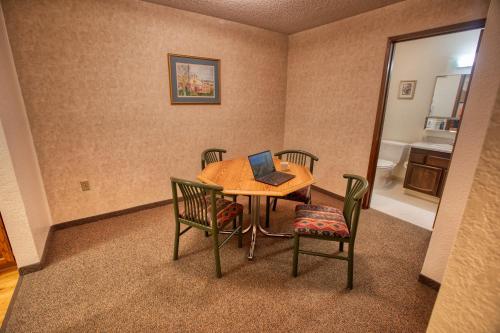 a dining room with a table with a laptop on it at Wedgewood Resort in Fairbanks