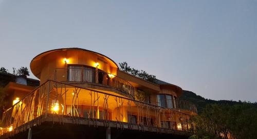 a circular building with lights on it at night at Sapa Clay House - Mountain Retreat in Sa Pa