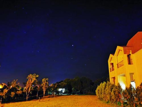 a large yellow building in a field at night at Taroko Mountain View B&B in Shunan