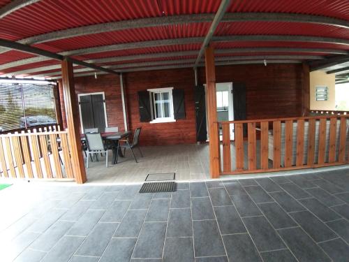 a screened in porch of a house with a table and chairs at Case Créole Soalaze in Salazie