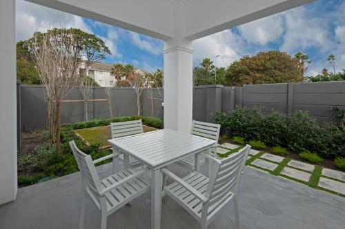 a white table and chairs on a patio at Perla in Hermanus