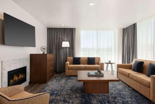 a living room with two couches and a fireplace at La Quinta by Wyndham San Luis Obispo in San Luis Obispo