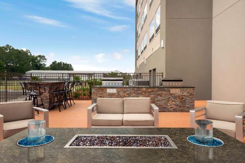 a patio with two chairs and a table on a building at La Quinta Brunswick/Golden Isles in Brunswick