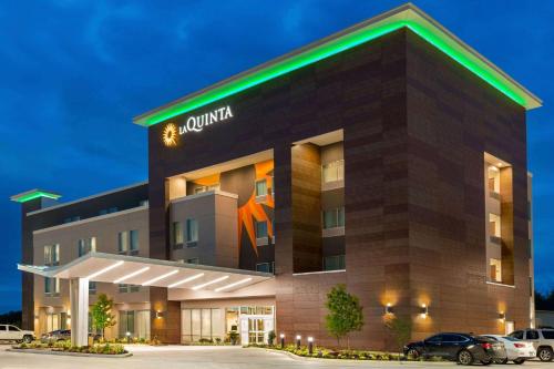 a rendering of a hotel building at night at La Quinta by Wyndham Richmond-Sugarland in Richmond