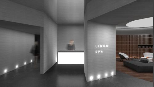 a lobby with a desk with a person sitting on it at Wanda Yi, Xi'an The Linow in Xi'an