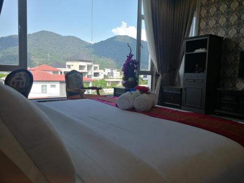 a bedroom with a bed with a view of a mountain at Casa Bianca in Kluang