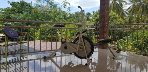 a bike hanging from a railing on a balcony at Khwahol Guesthouse in Don Sak