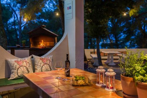 a table with a bottle of wine and a glass at Lavica Seaside Apartments, Podstrana in Podstrana