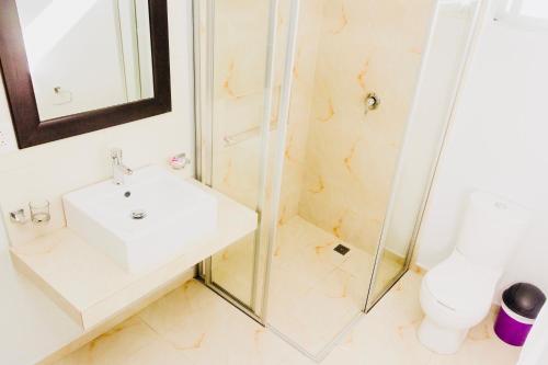 a bathroom with a sink and a shower at CondoHotel 5th Avenue Basic Double Studio in Playa del Carmen