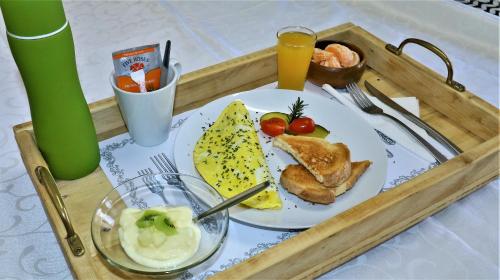 a tray with a plate of food on a table at Tiende Laan Bed & Breakfast and Self-Catering in Walvis Bay