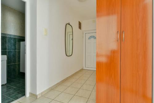 a room with a hallway with a mirror and a door at Apartment Ruzica in Sveti Stefan