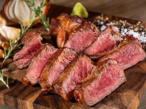 a pile of meat on a wooden cutting board at Hotel Mystays Kagoshima Tenmonkan in Kagoshima