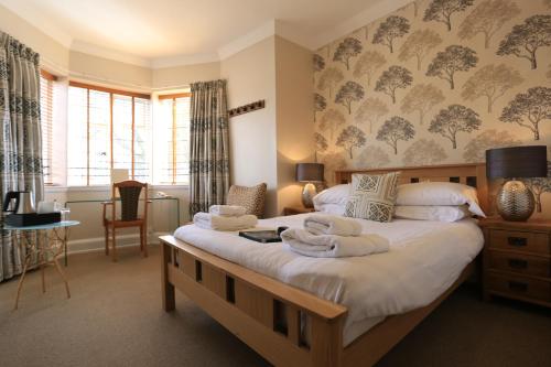 a bedroom with two beds with towels on them at B+B York in York