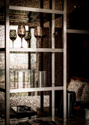 a shelf with three wine glasses on it at YOHO Hollywood Roosevelt Hotel in Macau