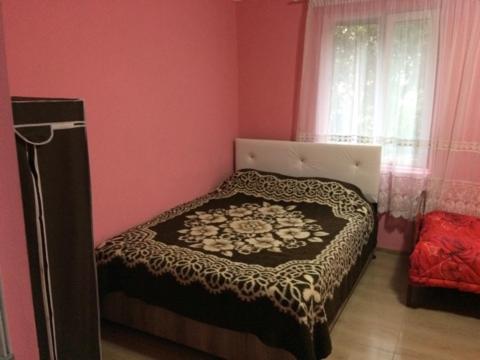 a bedroom with a bed in a pink room at House near The Black Sea in Makhinjauri