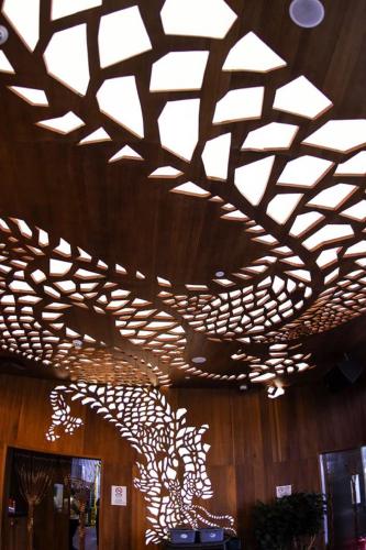a wooden ceiling in a building with lights on it at YOHO Hollywood Roosevelt Hotel in Macau
