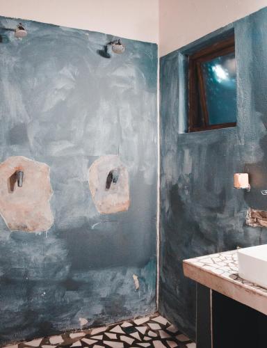 a blue wall in a bathroom with a sink at The Prawn Hatchery Pty Ltd on Amatikulu in Dokodweni