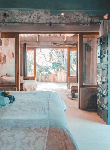a bedroom with a large bed and a large window at The Prawn Hatchery Pty Ltd on Amatikulu in Dokodweni