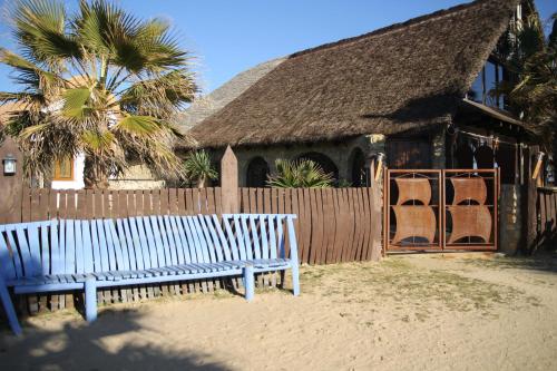 a blue bench sitting in front of a house at Habitaciones Sajorami Beach in Zahora