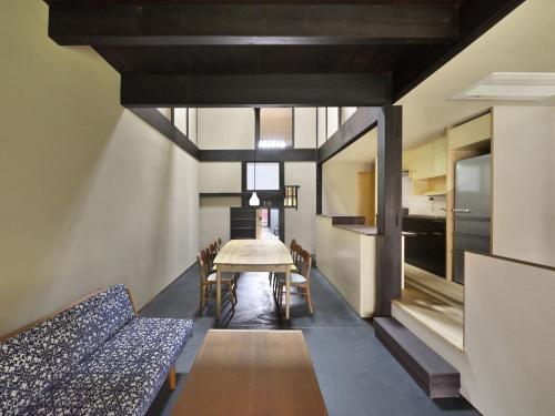 a kitchen and dining room with a table and chairs at Kyo no Ondokoro NISHIJIN VILLA #5 in Kyoto