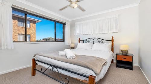a bedroom with a bed and a window at Beach Point - East Ballina in East Ballina