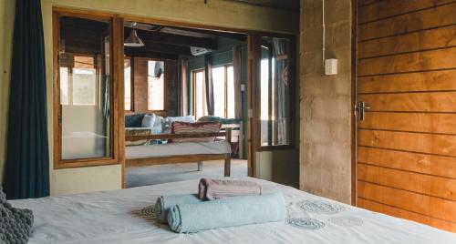 a bedroom with a bed and a view of a room at The Prawn Hatchery Pty Ltd on Amatikulu in Dokodweni