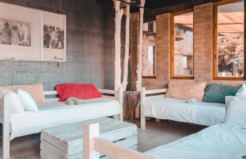 a room with two white beds and two windows at The Prawn Hatchery Pty Ltd on Amatikulu in Dokodweni