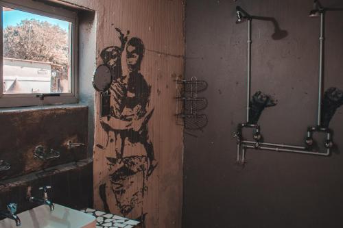 a bathroom with a painting of a man and a woman at The Prawn Hatchery Pty Ltd on Amatikulu in Dokodweni
