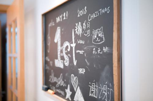a chalkboard with writing on it on a wall at Apartment Near Nanjing Road/ Jing'an Temple/ Renmin Plaza in Shanghai