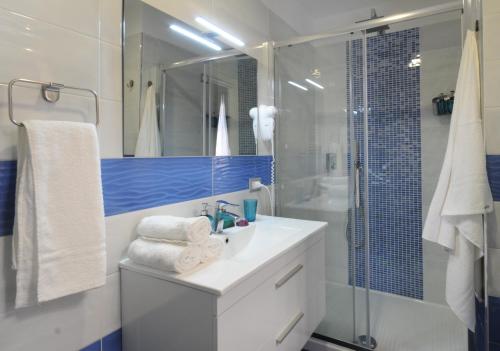 a bathroom with a white sink and a shower at Casa Sassolini in Naples