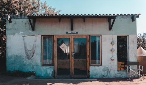 a building with a door with a sign on it at The Prawn Hatchery Pty Ltd on Amatikulu in Dokodweni