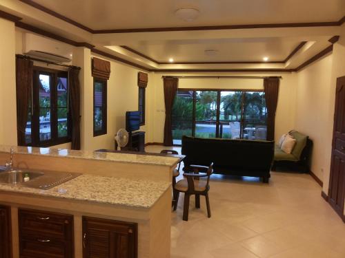 a kitchen with a counter top and a living room at Tulip Villa Oceanview in Ko Chang