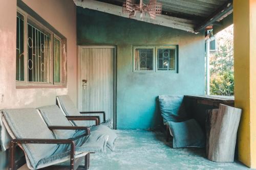 a group of chairs sitting on a porch at The Prawn Hatchery Pty Ltd on Amatikulu in Dokodweni