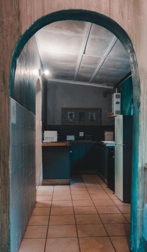 an archway in a kitchen with a refrigerator at The Prawn Hatchery Pty Ltd on Amatikulu in Dokodweni