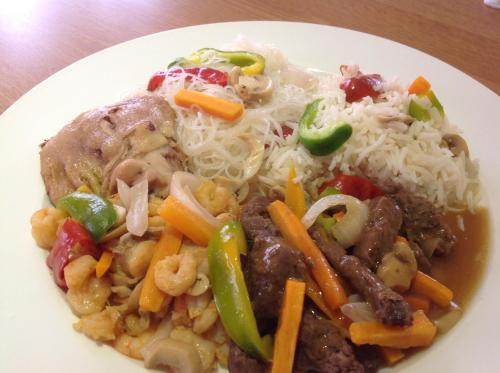 a plate of food with rice and meat and vegetables at Adis Hotels Ibadan in Ibadan