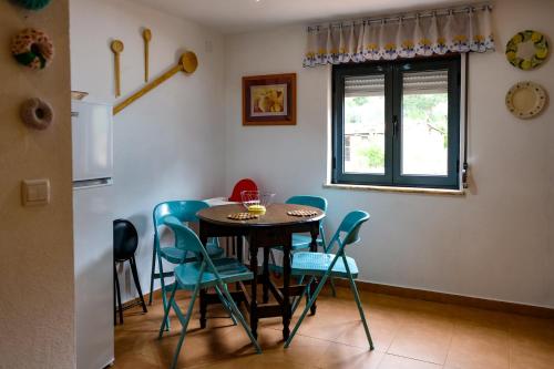 a dining room with a table and chairs and a window at Casa do Ferreiro II in Góis