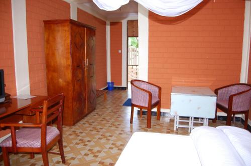a room with a table and chairs and a cabinet at Kakakuona Resort in Lushoto