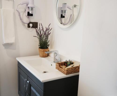 a bathroom with a sink and a mirror at Fuego Design Suites in Istanbul