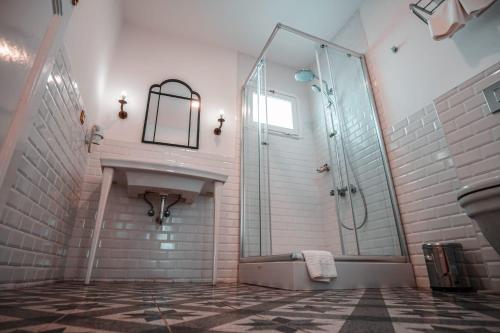 uma casa de banho com uma cabina de duche em vidro e um lavatório. em Rodosto Hotel em Tekirdağ