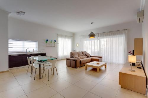 a living room with a couch and a table at Apartment In Fort Cambridge with Pool in Sliema